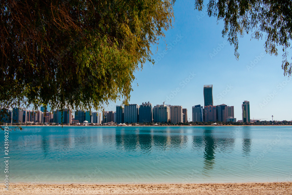 View of modern buildings from the canal shore in Abu Dhabi