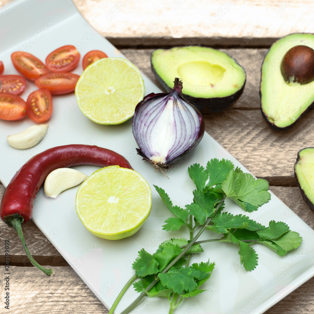 Avocado, onion, tomaten, chili, ingredients for guacomole Avocado, onion, tomaten, chili, ingredients for guacomole