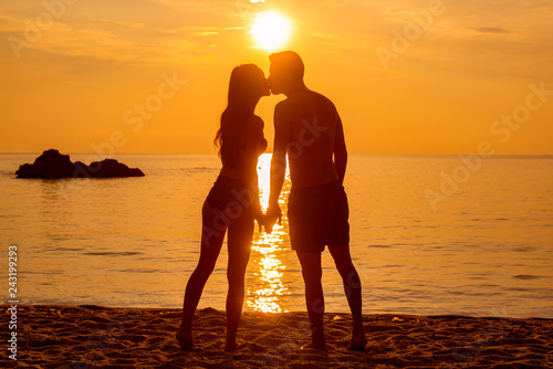 young couple is kissing at the sea