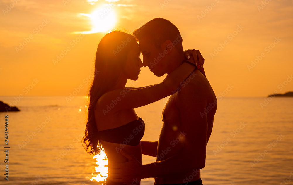 young couple is kissing at the sea