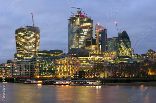London, England - The bank district of central London with famous skyscrapers and other landmarks at sunset with blue sky - UK - Immagine