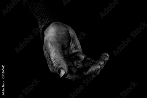 Helping hands concept, Old Man's hands palms up holding money coins, need care and support, reaching out, black and white