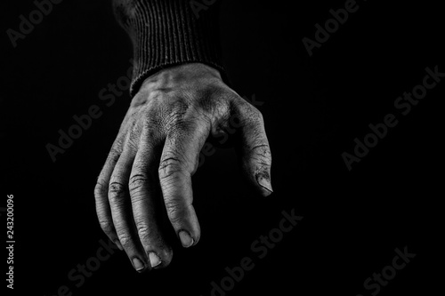 Helping hands concept, Man's hands reaching out, asking for help, black and white