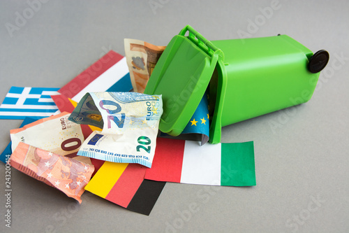 flags of the countries of the European Union, euro banknotes in the garbage can. concept of crisis  photo