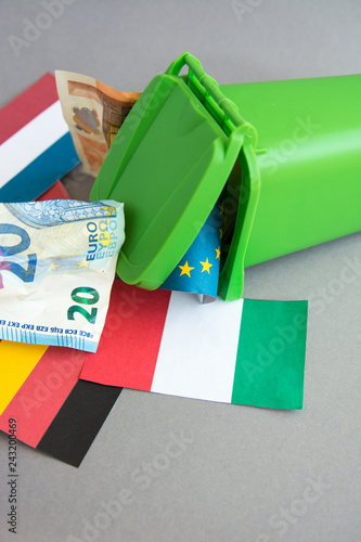 flags of the countries of the European Union, euro banknotes in the garbage can. concept of crisis  photo