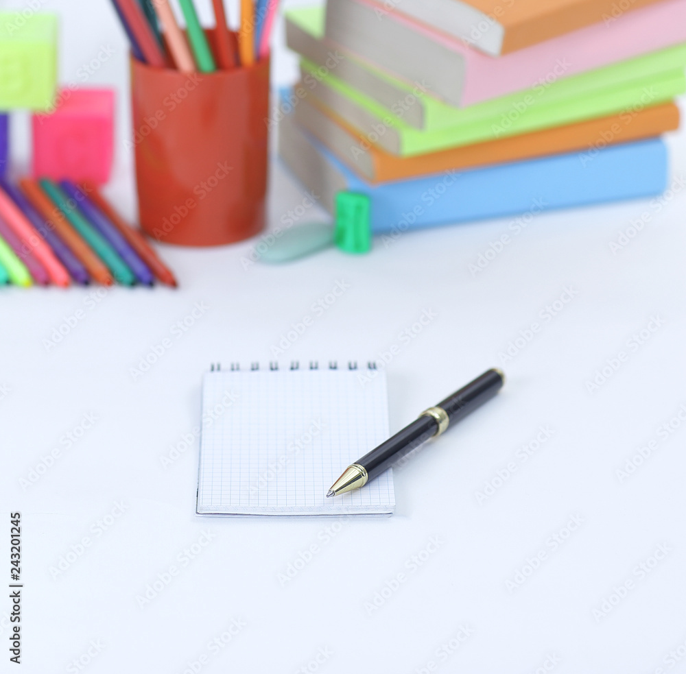 pen and Notepad on blurred background of school supplies .photo with copy space pen and Notepad on blurred background of school supplies .photo with copy space