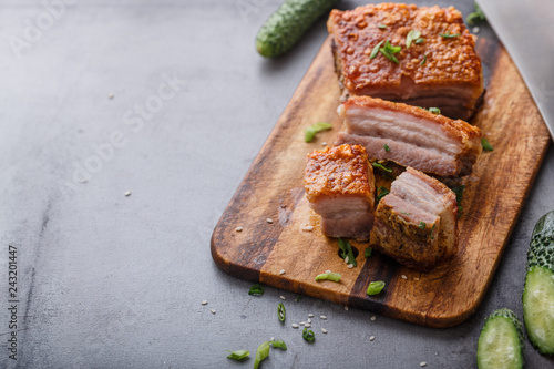 Chinese roasted pork belly on wooden cutting board copy space photo
