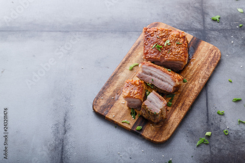 Thai crispy skin pork belly on wooden board, copy space