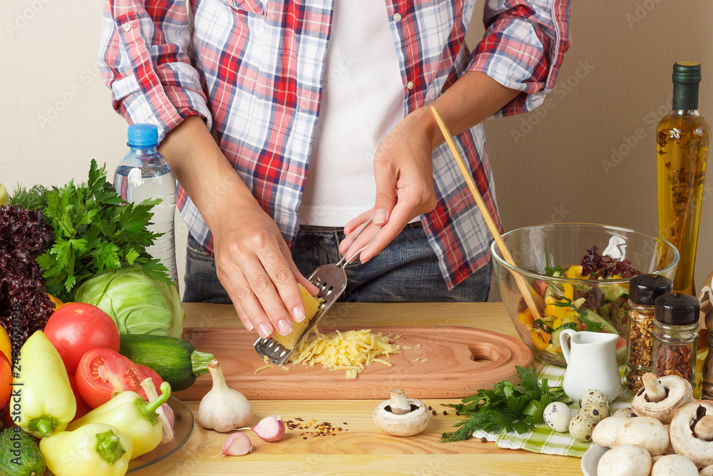 Woman cooks at the kitchen, body part, blurred background Woman cooks at the kitchen, body part, blurred background