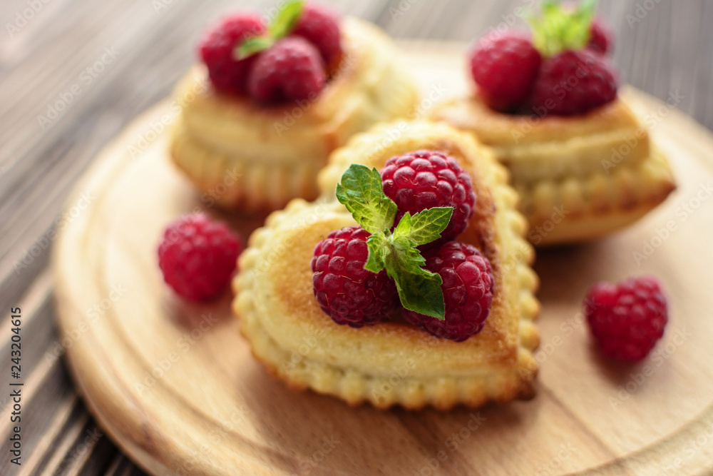 Delicious heart-shaped muffins with raspberries and mint. Cupcakes for Valentine's Day Delicious heart-shaped muffins with raspberries and mint. Cupcakes for Valentine's Day