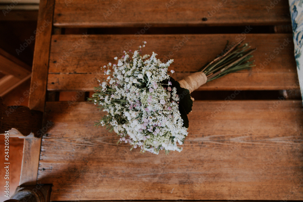 Aerial view of a bridal bouquet on a wooden table