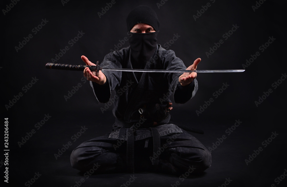 Ninja samurai holds katana in a hands Stock Photo