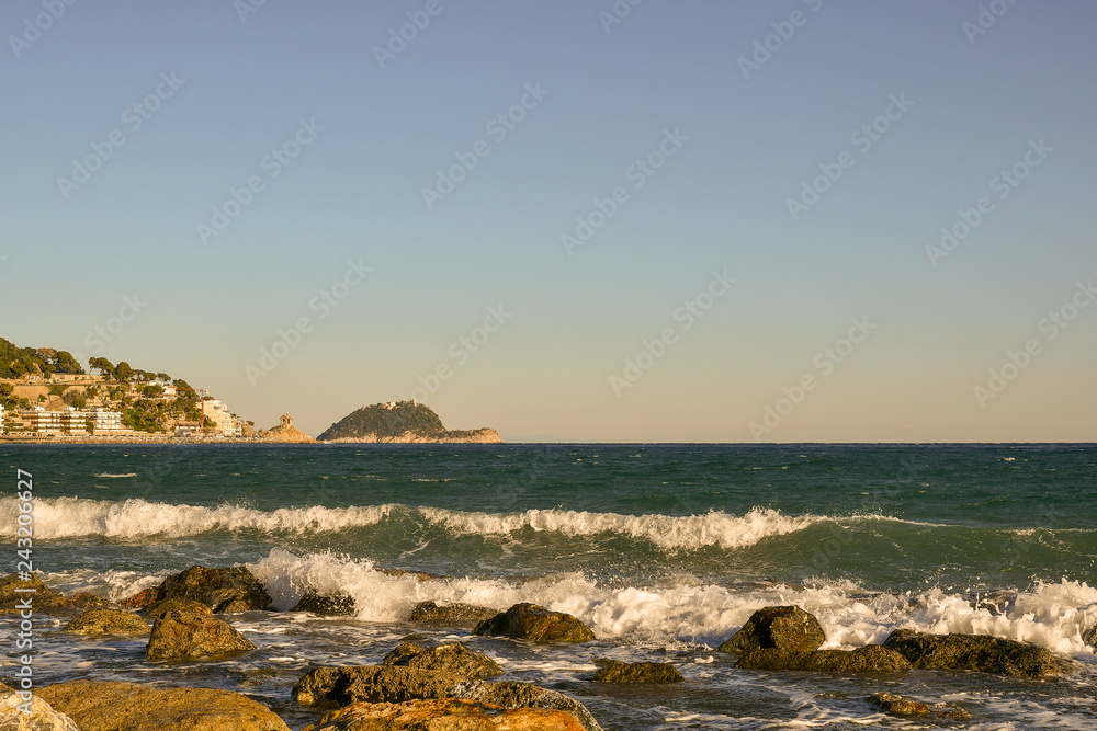 Scenic view of the Ligurian Sea with rocks, Gallinara Island and Cappelleta chapel, Alassio, Liguria, Italy