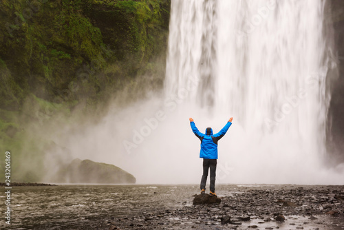 Man near waterfall