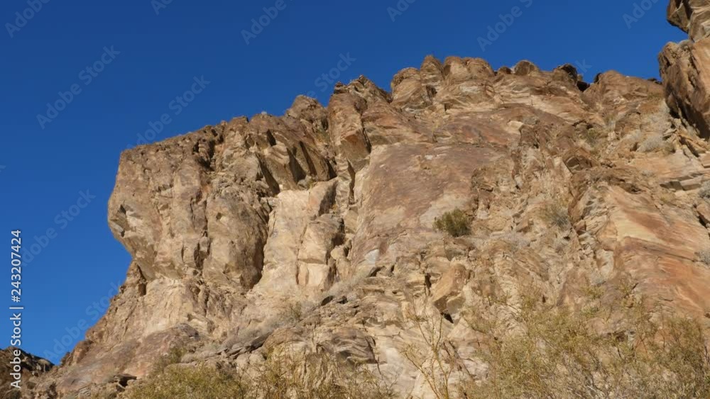 Low angle view of sunlit cliff face. Andreas Canyon, Palm Springs, California. Low angle view of sunlit cliff face. Andreas Canyon, Palm Springs, California.