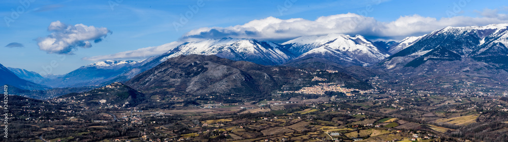 wide winter panorama of the Italian Comino valley under the Marsicani mountain range