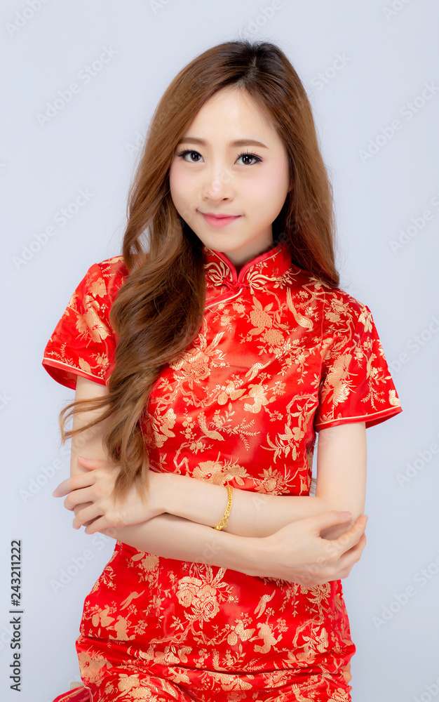 Beautiful portrait happy Chinese New Year young asian woman wear cheongsam smile with gesture congratulation and greeting isolated on white background, festival and celebrate concept. Beautiful portrait happy Chinese New Year young asian woman wear cheongsam smile with gesture congratulation and greeting isolated on white background, festival and celebrate concept.