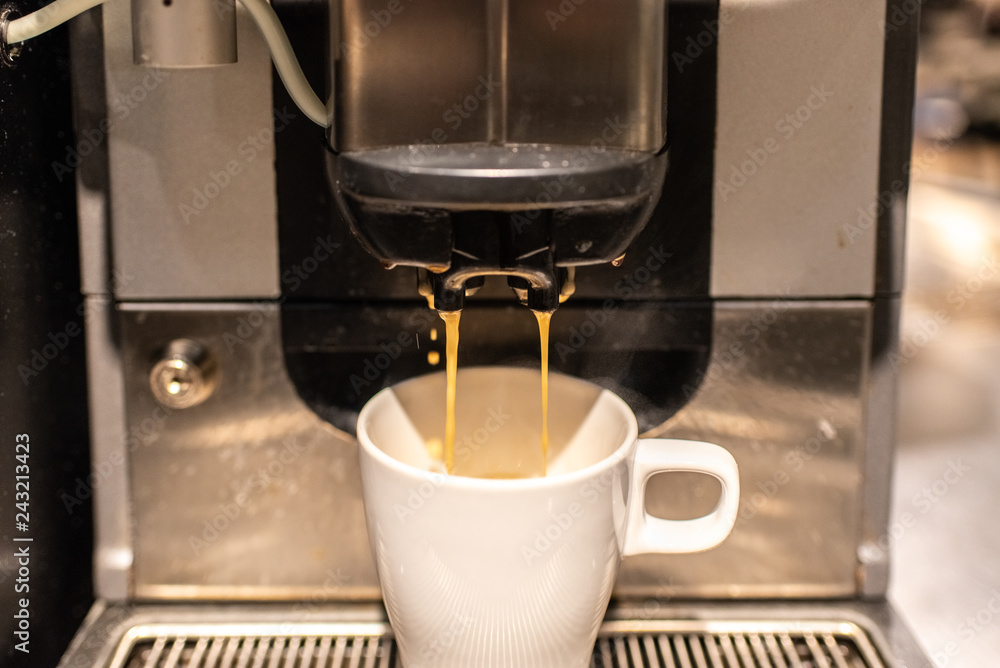 Industrial coffee maker preparing a coffee with milk. Industrial coffee maker preparing a coffee with milk.
