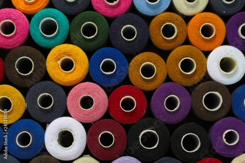 colorful spools of thread abstract background