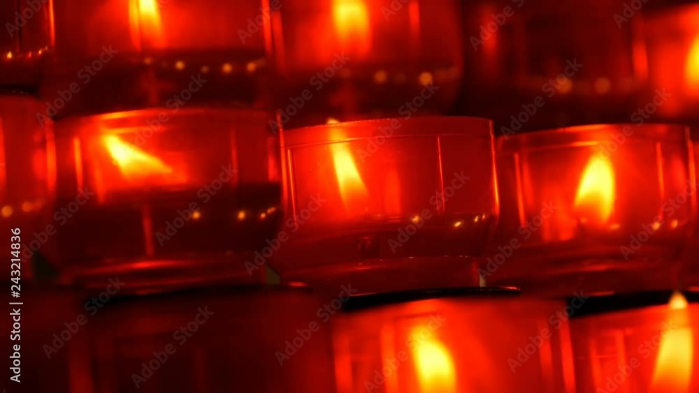 Burning memorial candles in Catholic church. Row of christian prayer