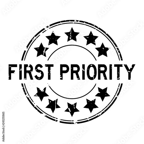 Grunge black first priority word with star icon round rubber seal stamp on white background