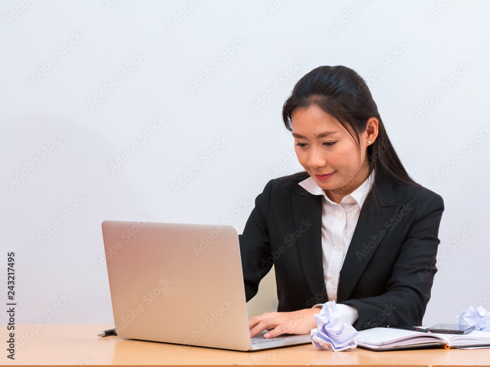 Asian woman using laptop for making report on white background Asian woman using laptop for making report on white background