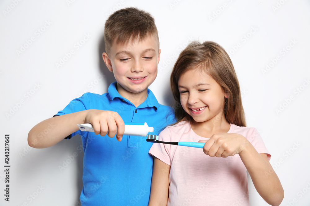Cute children with toothbrush and paste on white background Cute children with toothbrush and paste on white background