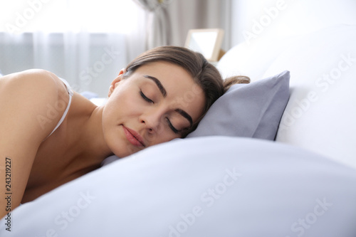 Young woman sleeping on soft pillow. Bedtime