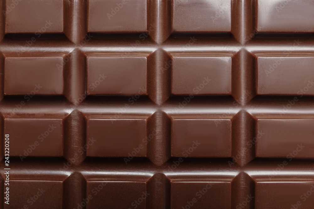 Tasty dark chocolate bar as background, top view Tasty dark chocolate bar as background, top view
