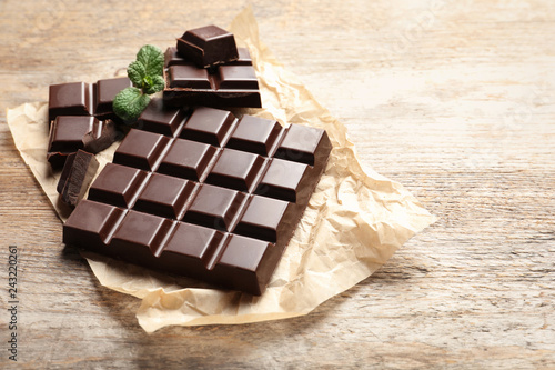 Tasty chocolate on wooden background. Space for text