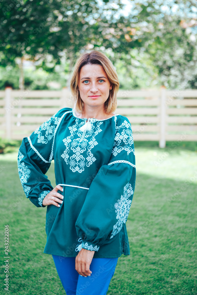 Beautiful young woman in traditional ethnic ukrainian style. Green and white embroidery Beautiful young woman in traditional ethnic ukrainian style. Green and white embroidery
