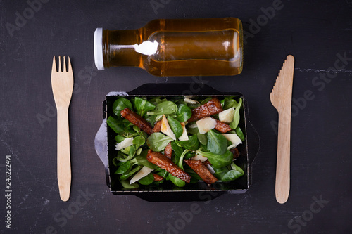 meal prep container with salad  and bottle with juice