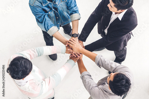 Top view of successful of group business people stack and putting their hands together at office.Friendship teamwork concept