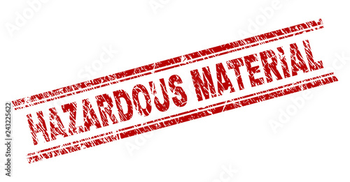 HAZARDOUS MATERIAL seal print with grunge texture. Red vector rubber print of HAZARDOUS MATERIAL tag with scratched texture. Text caption is placed between double parallel lines.