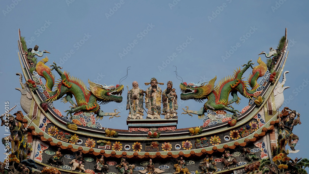 Fototapeta premium Chinese god sculpture on roof top of chinese temple and some space for write wording, special unique design in chinese style
