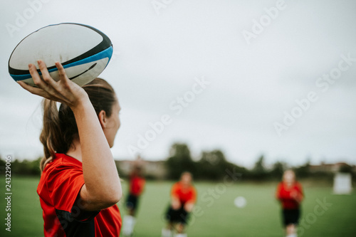 Female rugby player holding a ball photo