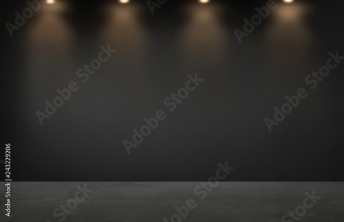 Black wall with a row of spotlights in an empty room photo