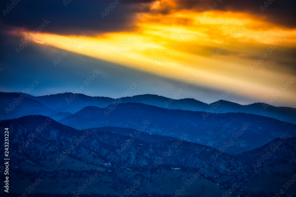 sunset and sun rays and beams in mountains