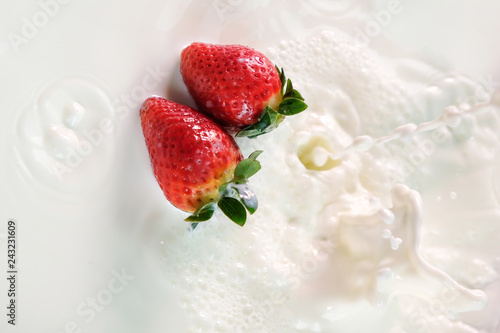 fresh strawberry splashes in to milk spread