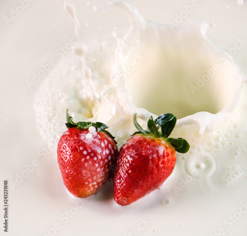fresh strawberry splashes in to milk spread
