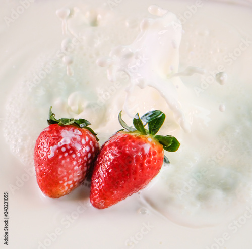fresh strawberry splashes in to milk spread
