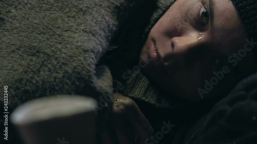 Person donating to homeless boy, street child suffering cold and diseases