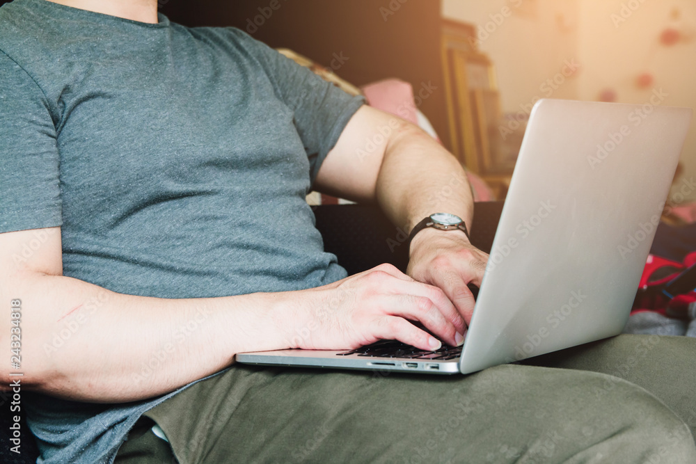 Young Business man sitting hands using laptop in bedroom on desk at home Young Business man sitting hands using laptop in bedroom on desk at home