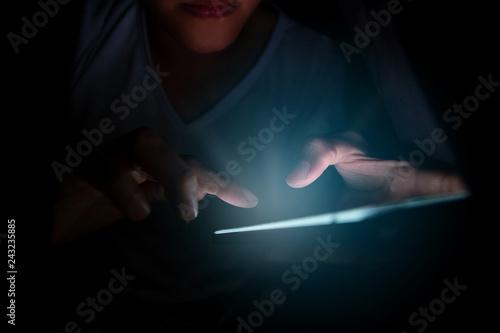 Obraz na plátne Close-up young man sitting on the bed using smartphone at late night, Phone disease and Nomophobia