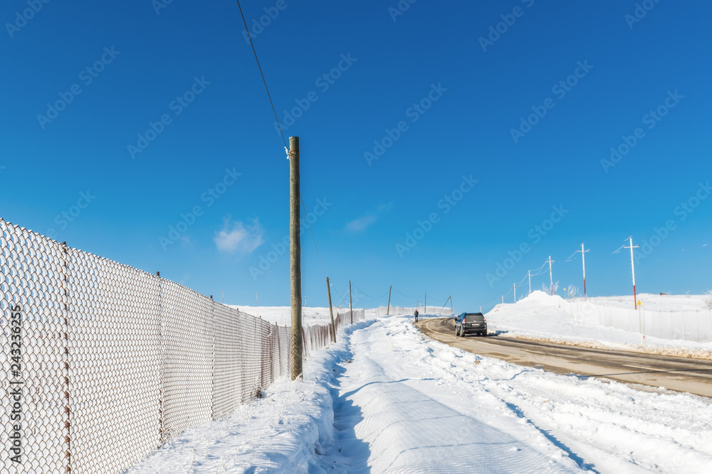 Snow fence along the road, winter scene