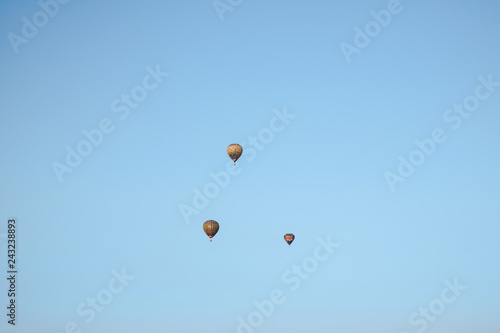 multicolored balloons in the city festival on blue sky background