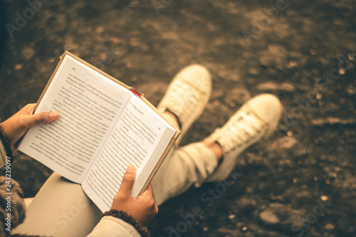 Women in winter sit read favorite book in the holiday, Concept girl reading a book.