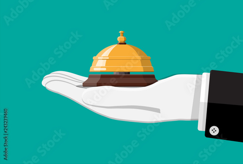 Golden service bell in hand