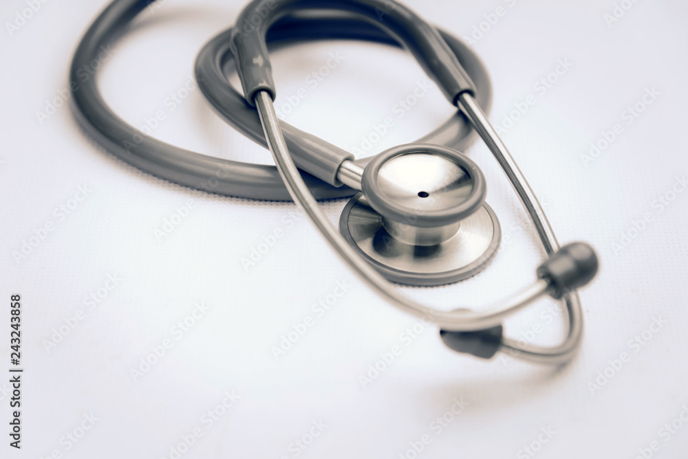 Gray stethoscope medical equipment on white canvas. instruments device for doctor. medicine concept Gray stethoscope medical equipment on white canvas. instruments device for doctor. medicine concept