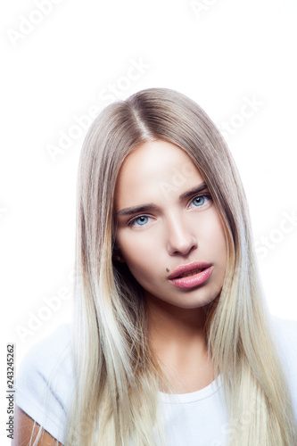 Lifestyle portrait of beautiful fashion model girl wearing white t-shirt. Natural make-up, hai style, clean skin. White background